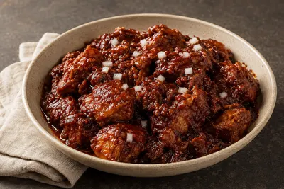 Tender pork shoulder coated in a glossy brick-red dried-chile sauce